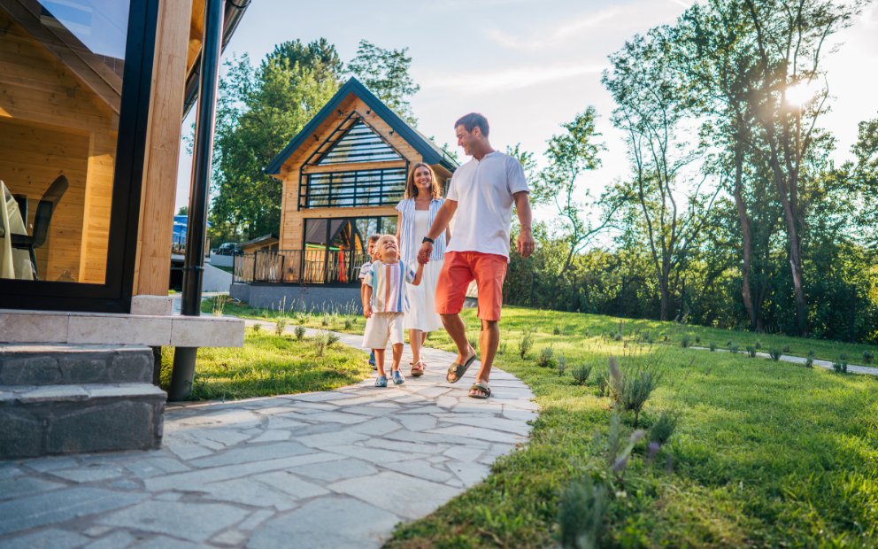 Young family of three waqlking on property and enjoying their luxury home renovations
