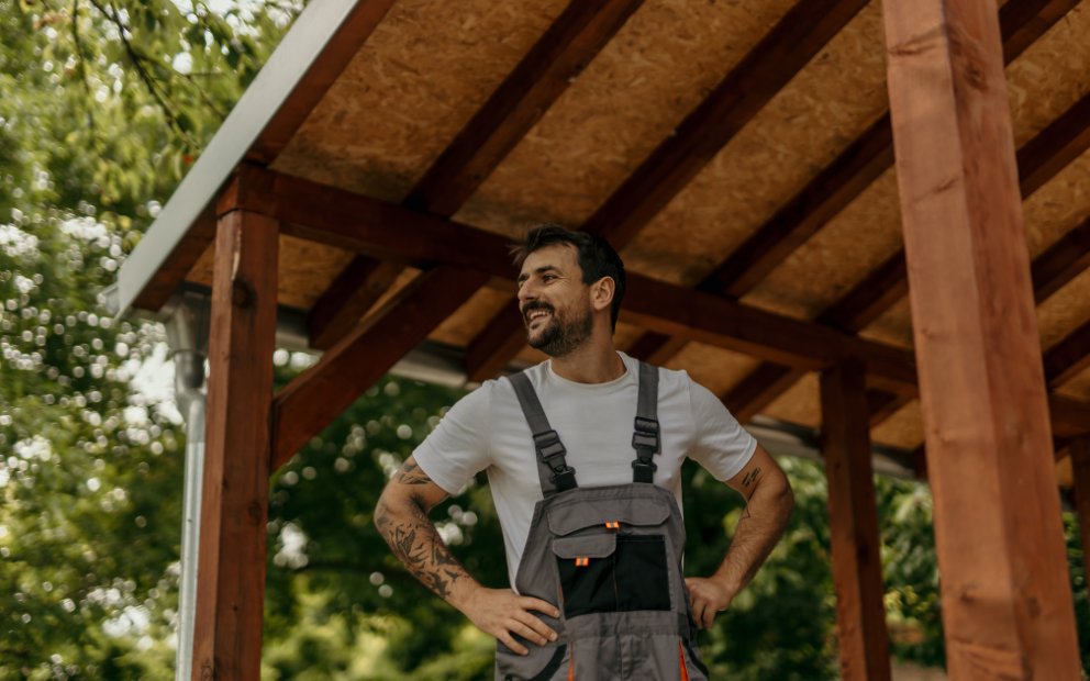 Man outside his home glad he used home equity for home improvements