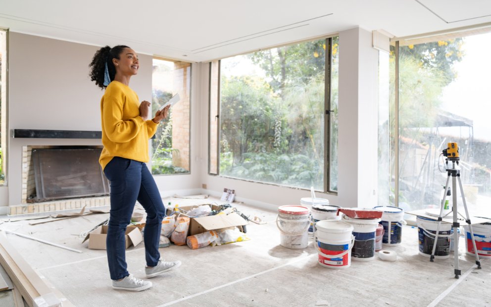 Woman standing in her living room about to renovate with home equity