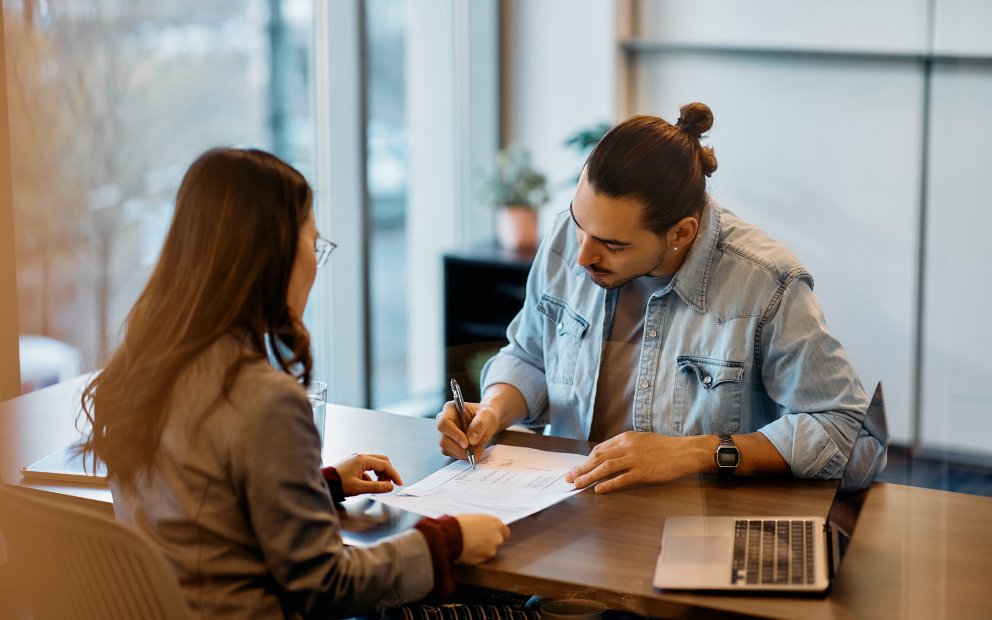 Young man signing contract to obtain fha duplex loan
