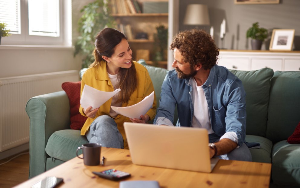 Young couple sitting together at home while they review and discuss heloc interest only payments