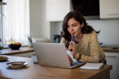 Woman sitting at home desk researching Financing an Investment Property