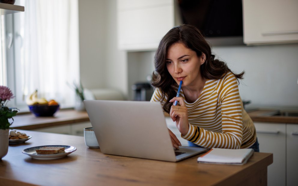Woman sitting at home desk researching Financing an Investment Property