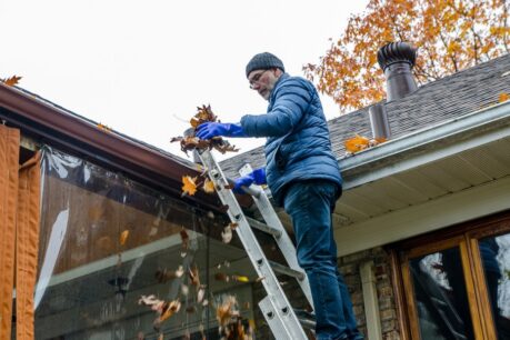 Homeowner working through their Fall home maintenance checklist