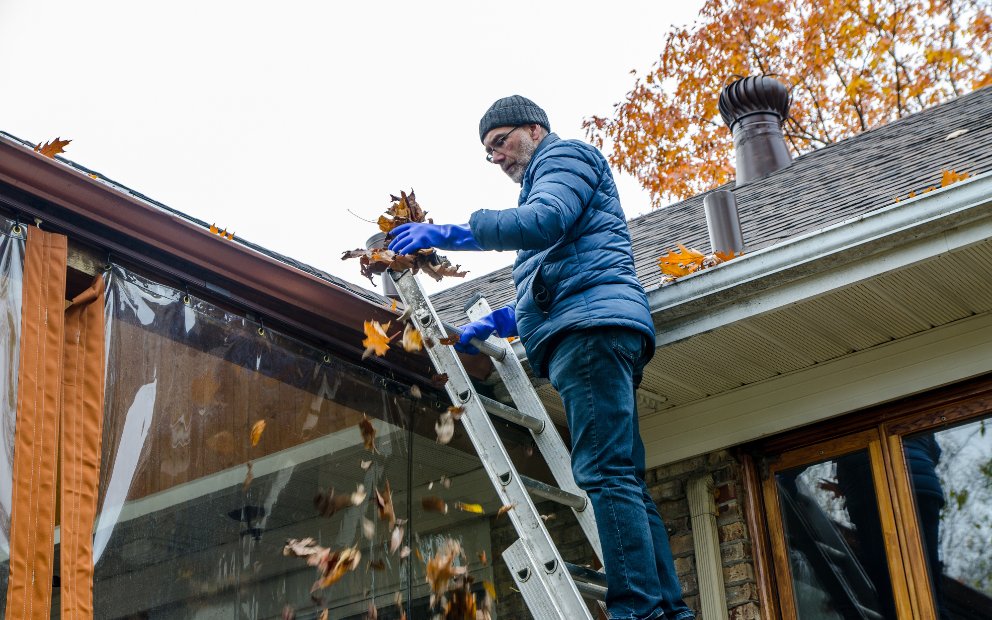 Homeowner working through their Fall home maintenance checklist