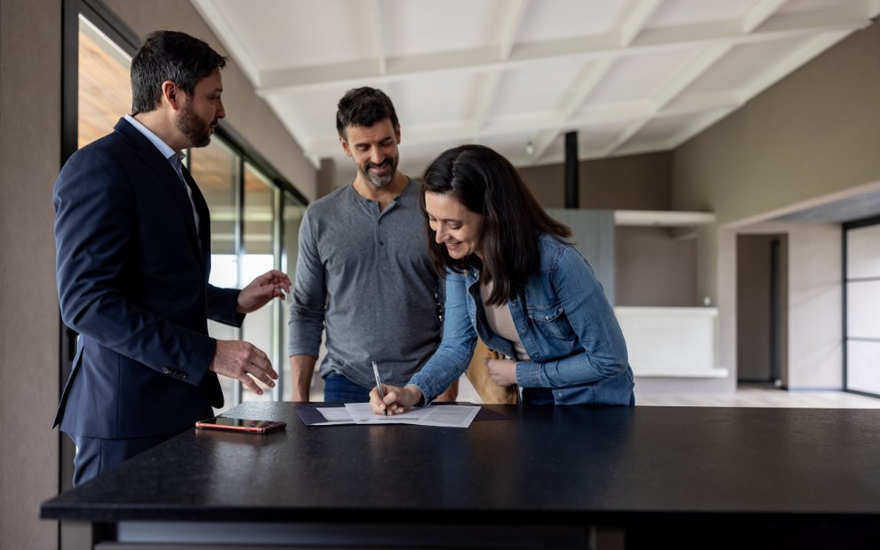 Young man and woman adult couple signing lease for conventional loan duplex