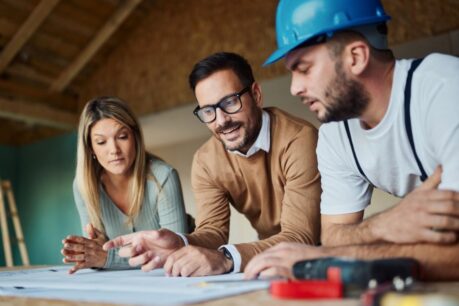 Man and woman couple speaking to builder after using va construction loan draws