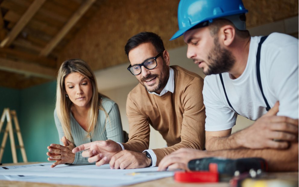 Man and woman couple speaking to builder after using va construction loan draws