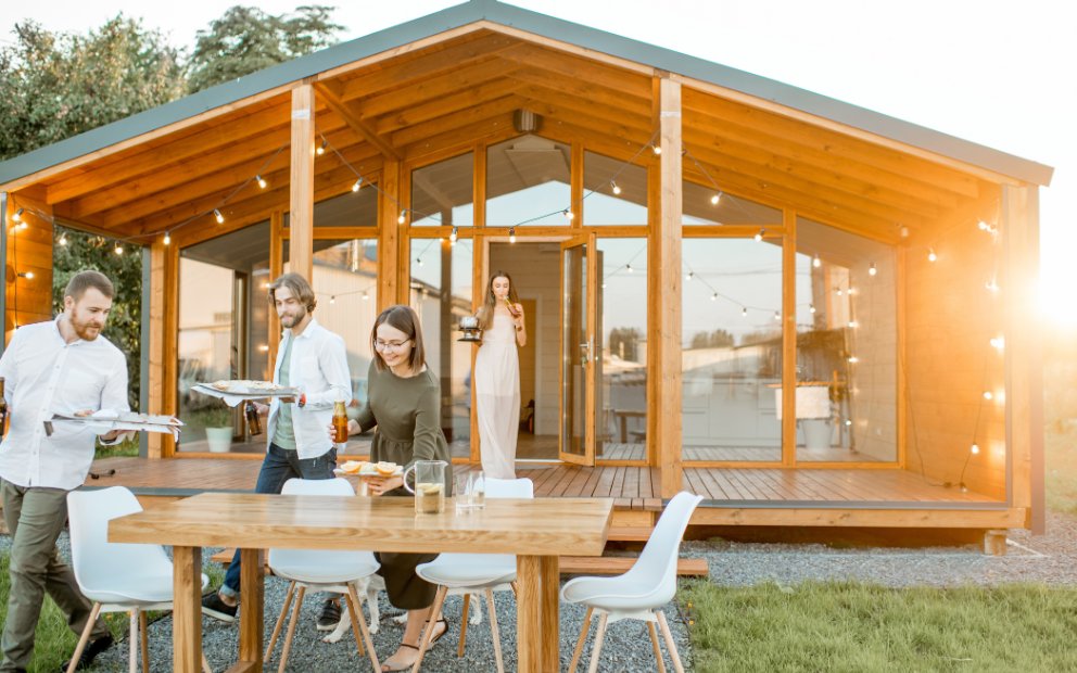 Young group of friends in yard happy that they asked What are Modular Homes?