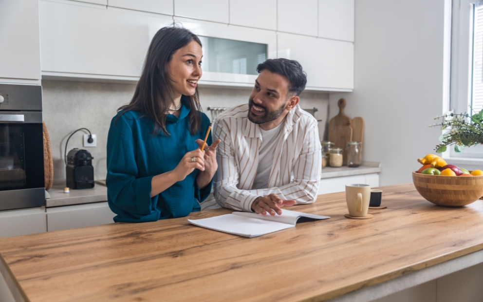Young couple at home looking into home equity loan for wedding