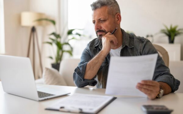 Middle-aged man at home differentiating between va cash out refinance from conventional