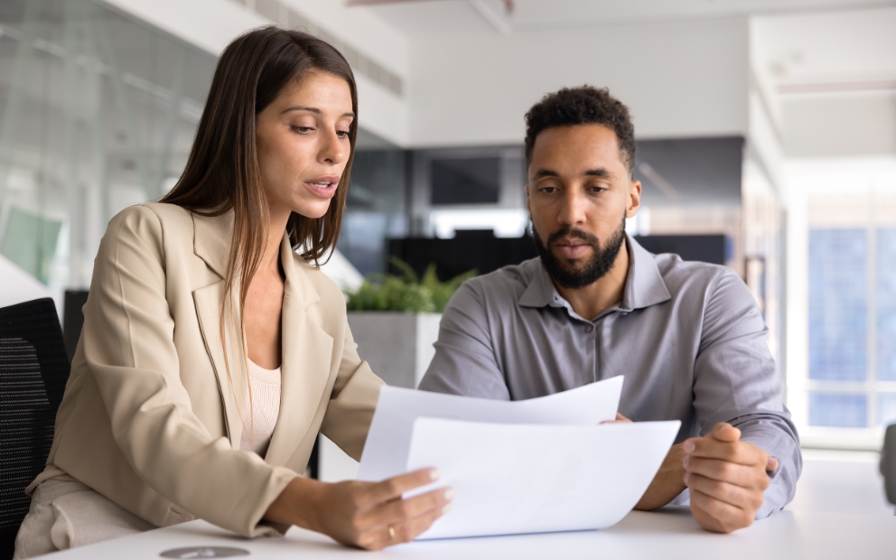Young mand and woman couple at home reviewing home equity loan closing costs together