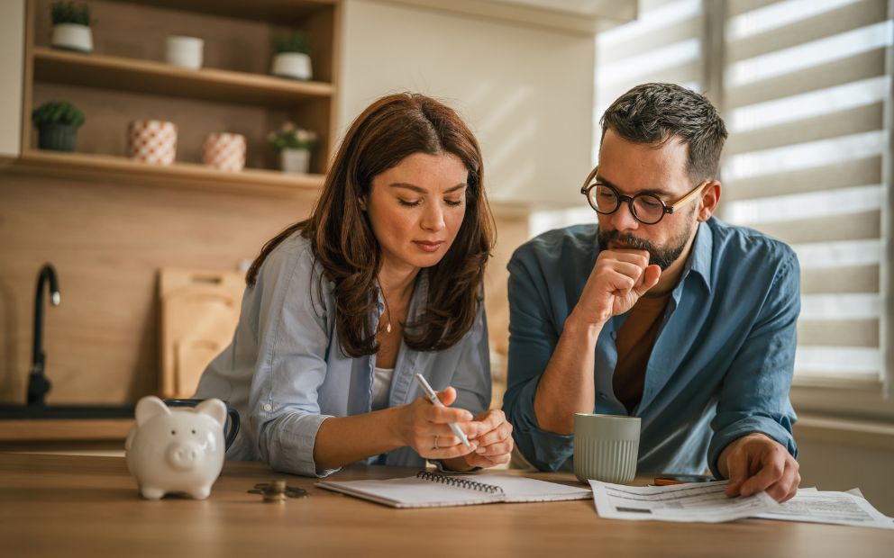 Young man and woman couple at home reviewing mortgage options when moving in 5 years