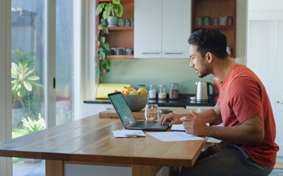 Young adult man looking over information on 2026 housing ballot measures