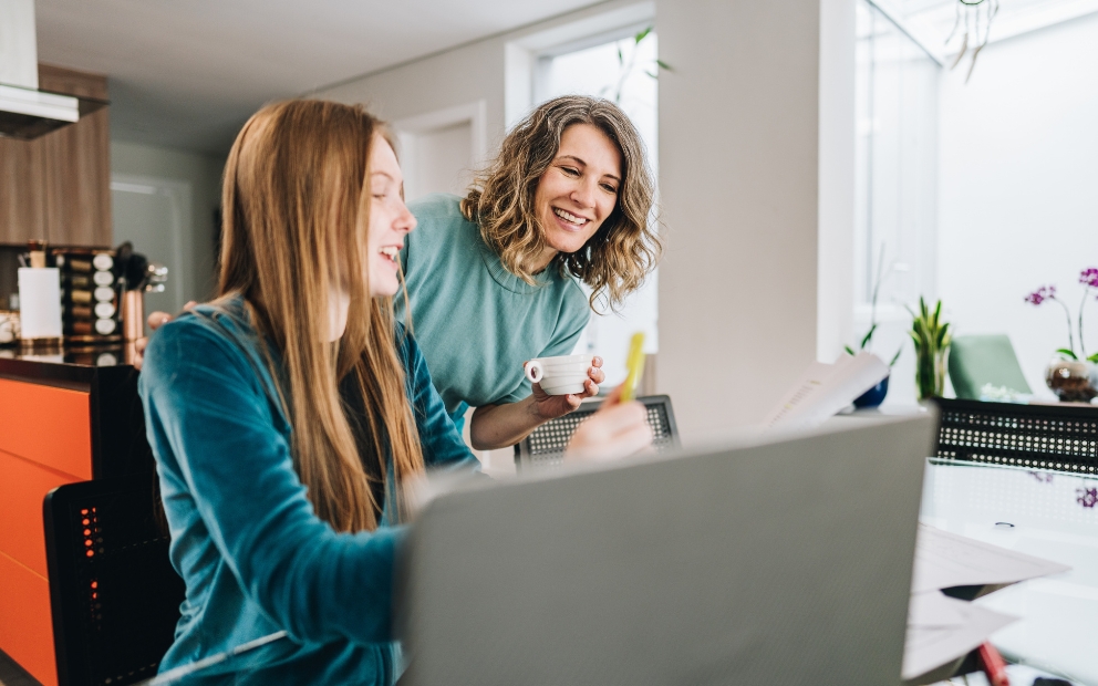 Mother helping daughter research before buying a house for college student