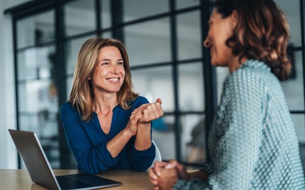 Adult women happily discussing the importance of Jumbo loan reserves