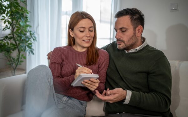 Couple writing a letter to seller